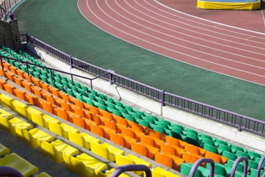 Rows of plastic seats at stadium