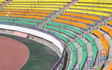 Rows of plastic seats at stadium