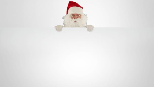 Santa Claus appears behind a white sheet with space for text — Stock Video