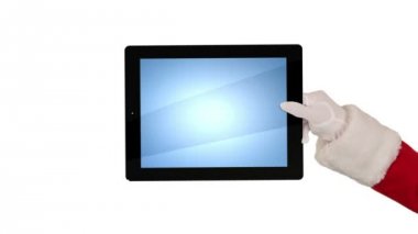 Noel Baba bir tablet sunulması sonra bir öpücük göndermek ve karşı beyaz güle güle demek