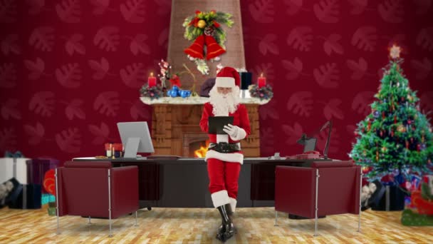 Santa Claus taking notes on a clipboard in his modern Christmas Office — Stock Video