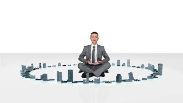 Businessman meditating with buildings rising around him — Stock Video