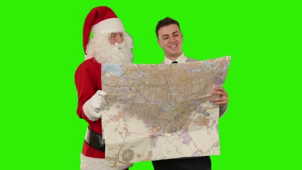 Санта-Клауса з молодих бізнесмен, читання карти — стокове відео