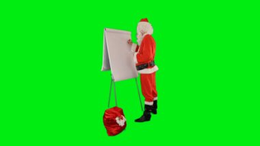 Bir çanta dolusu hediyeyle Noel Baba iyi ve kötü çocuklarla dolu bir liste yapıyor, Yeşil Ekran Chromakey
