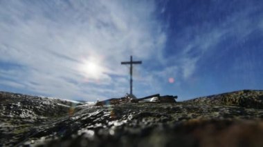 Crucifixion of Jesus Christ with thorn crown, nails, hammer and a rope against rain sky