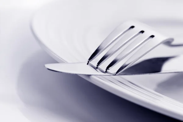 Knife and Fork on Plate Soft Focus Stock Picture