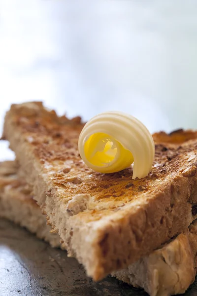 Máslo oblouček na toastu — Stock fotografie