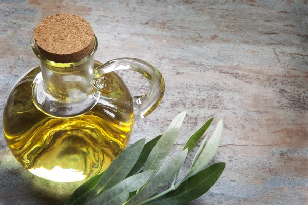 Olive Oil and Olive Leaves on Rustic Timber — Stock Photo, Image