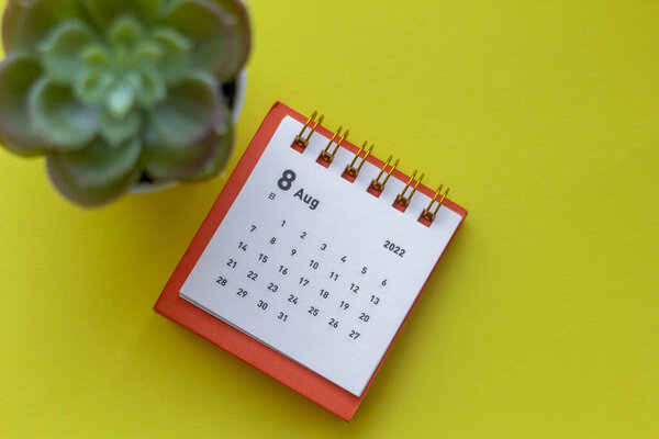 Desktop calendar for August 2022 on the table