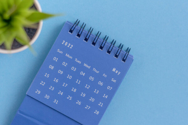 Desktop blue calendar for May 2022 on a blue background