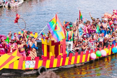 Pride Parade of lesbian, gay, bisexual, transgender, queer and allies. LGBTQ participate in Canal Parade, people in colorful costumes dancing, smiling - Netherlands, Amsterdam, August 6, 2022.