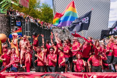 Pride Parade of lesbian, gay, bisexual, transgender, queer and allies. LGBT raindow pride flag, people in colorful costumes dancing, smiling, boating - Netherlands, Amsterdam, August 6, 2022.