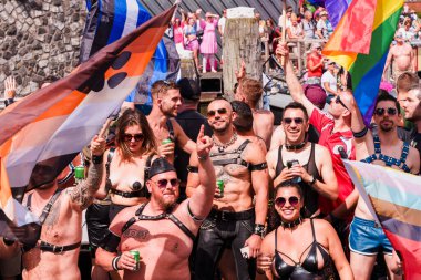 Pride Parade of lesbian, gay, bisexual, transgender, queer and allies. People s in leather bondage costumes with Gay leather and Bear Brotherhood Pride flags - Netherlands, Amsterdam, August 6, 2022