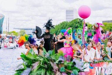 Pride Parade of lesbian, gay, bisexual, transgender, queer and allies. Close up LGBTQ people in colorful costumes dancing, smiling, having fun - Netherlands, Amsterdam, August 6, 2022.