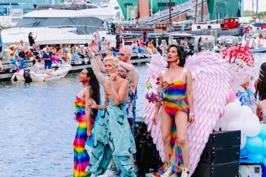 Pride Parade of lesbian, gay, bisexual, transgender, queer and allies. Close up LGBTQ people in colorful costumes dancing, smiling, having fun - Netherlands, Amsterdam, August 6, 2022.