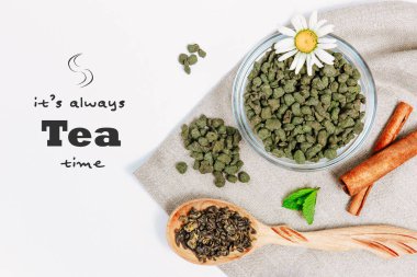 Design mockup with tea phrase. Fresh harvest of tea leaves on white background, top view, copy space. Assortment or variety tea leaves, Afternoon tea concept, desserts, warming drink during low season.