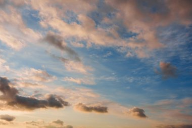Fairy sunset sky with fluffy clouds. Sunset sky natural background. Dramatic Sky. Sunset In Yellow, Orange, Pink Colors. Feeling of dream or freedom. Copy space.