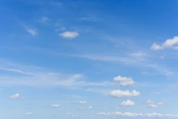 Daytime summer blue saturated sky with blurry clouds. Feeling of freedom, clarity of mind, dreaminess. Postcards, copy space, banner.