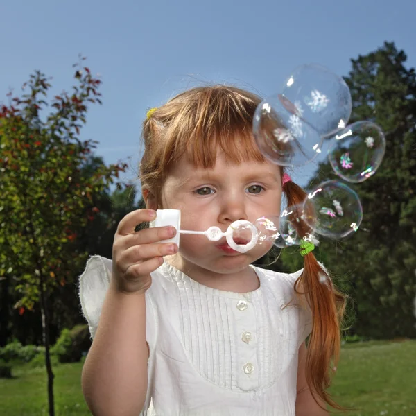 Girl play in bubbles — Stock Photo, Image