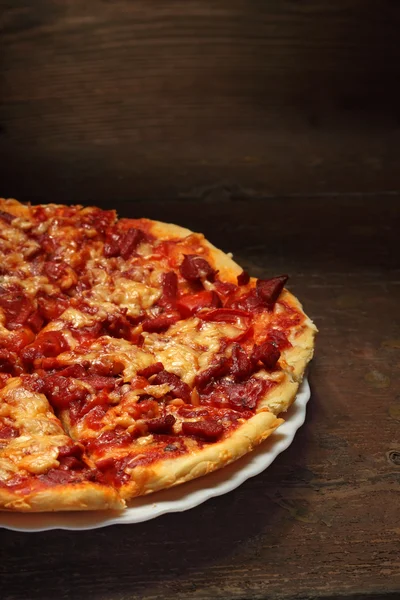 Round pizza on wood background — Stock Photo, Image