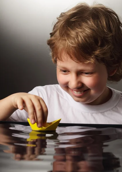 Paper ship in children hand — Stock Photo, Image