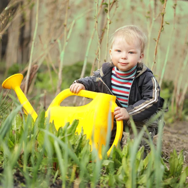 Boy watering sprout — Stock Photo, Image