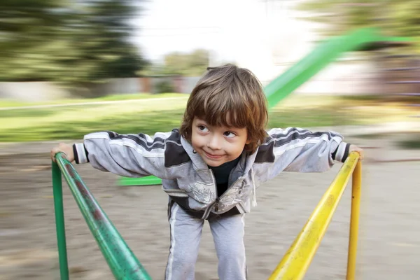 Niño feliz en carrusel al aire libre —  Fotos de Stock