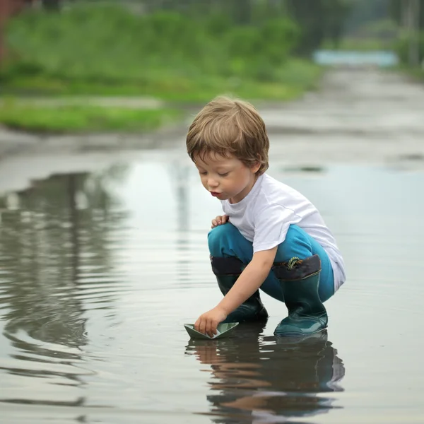 Paper ship in children hand — Stock Photo, Image