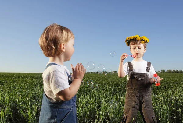 Two boys play in bubbles — Stock Photo, Image