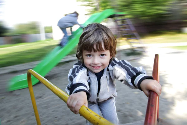 Niño feliz en carrusel al aire libre —  Fotos de Stock