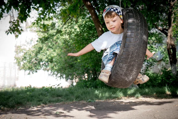 Happy boy on swing — Stock Photo, Image