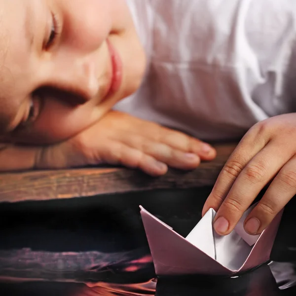 Paper ship in children hand — Stock Photo, Image