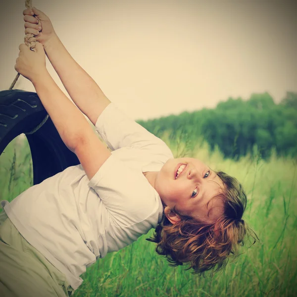 Feliz chico en swing al aire libre —  Fotos de Stock