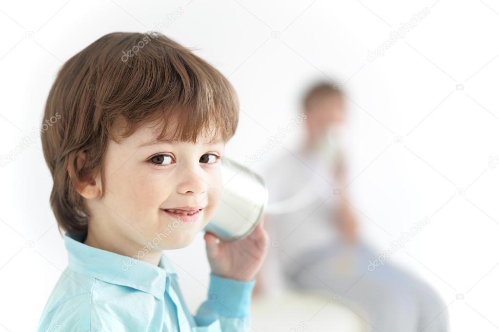 two happy boy play in the tin can phone