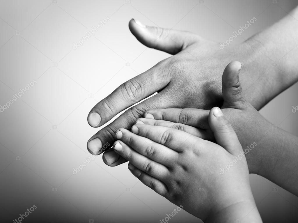 children and adults hands on a white background