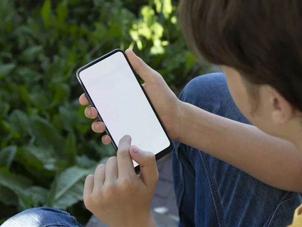 Teenager Holding Black Smartphone Blank Screen Modern Frameless Design Nature — Zdjęcie stockowe