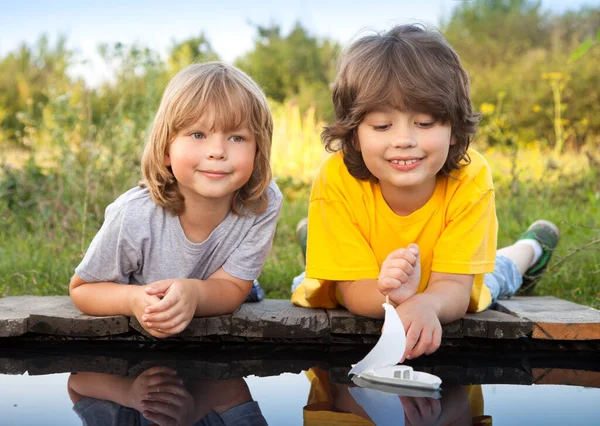 Two Boys Allowed Paper Boats Pier River — Stock Photo, Image