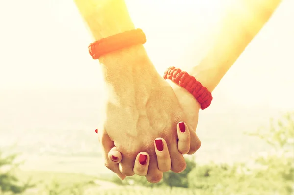 Couple holding hands on a sunny day