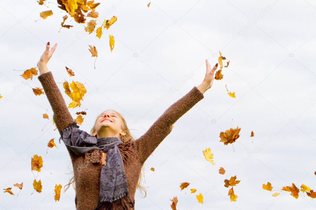 Happy girl on a windy day in autumn