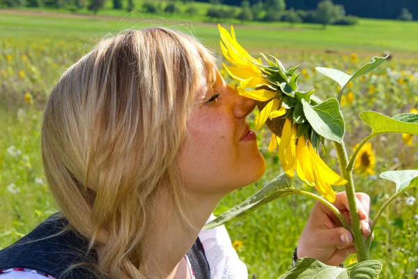 Girl Smells Sunflower Royaltyfria Stockfoton