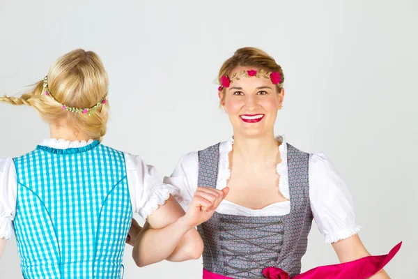 Two Happy Girls Colorful Dirndl lizenzfreie Stockfotos