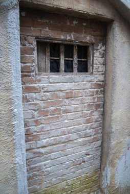 Ortaçağ hapishane duvarında tuğlalar ve parmaklıklar var. Ortaçağ cezası