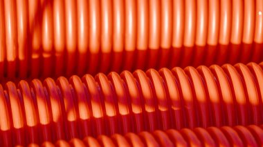 Red corrugated plastic tubes. Industrial background. Products from plastic. Drainage and sewerage. Urban network.