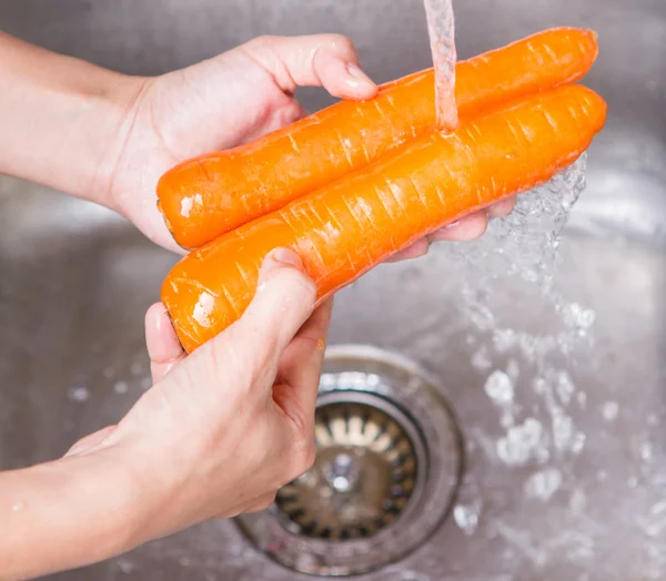 Мытье морковных овощей — стоковое фото
