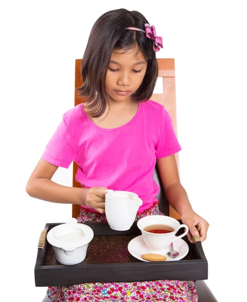 Little Asian girl drinking tea whit pleasure — Stock Photo, Image