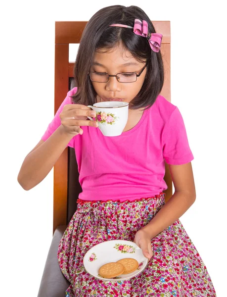 Little Asian girl drinking tea whit pleasure — Stock Photo, Image