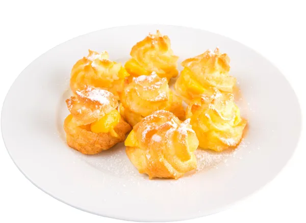 Home made cream puff on a white plate — Stock Photo, Image