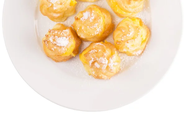 Home made cream puff on a white plate — Stok Foto