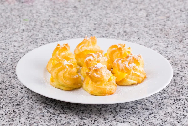 Home made cream puff on a white plate — Stock Photo, Image