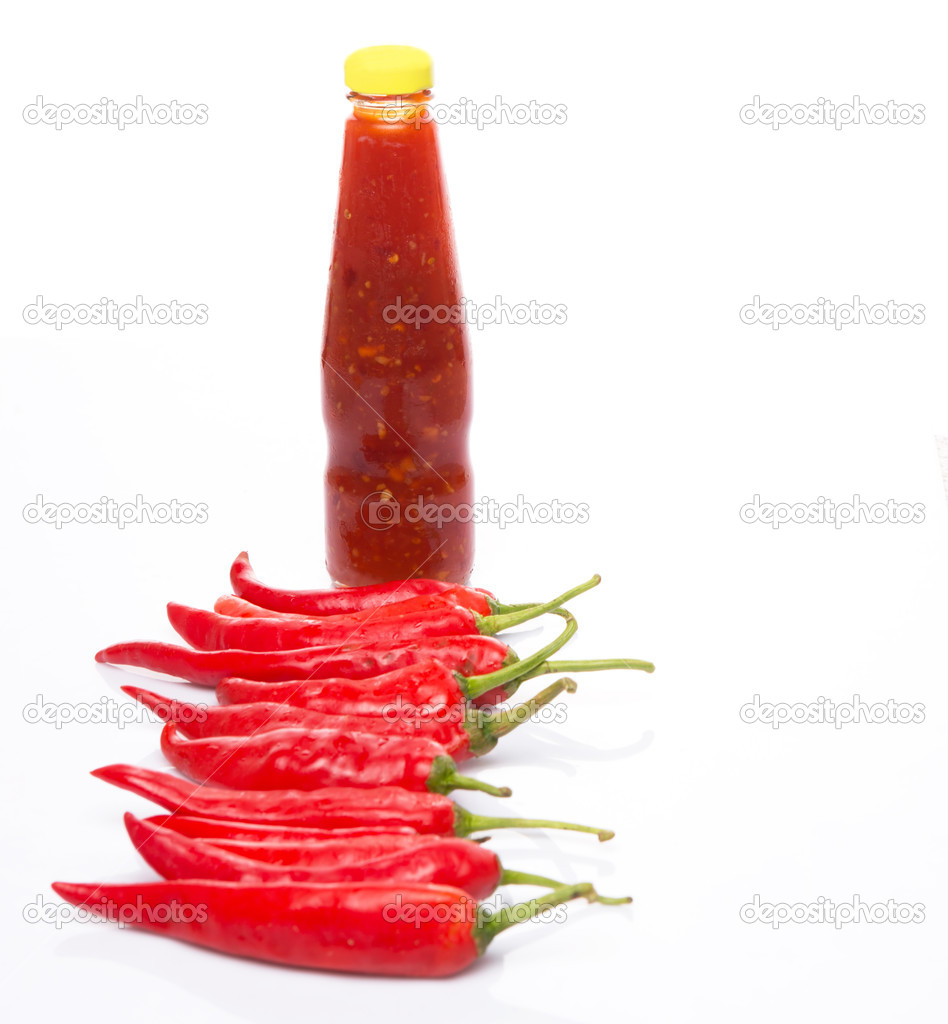A bottle of chillie sauce and fresh chilli